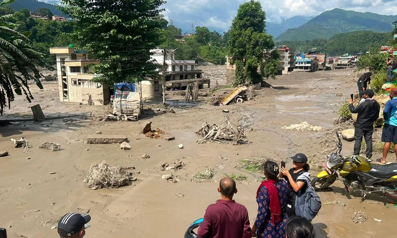 At least 22 people have died and 384 tourists and travellers are missing after devastating flash floods struck Nepal near the China border.